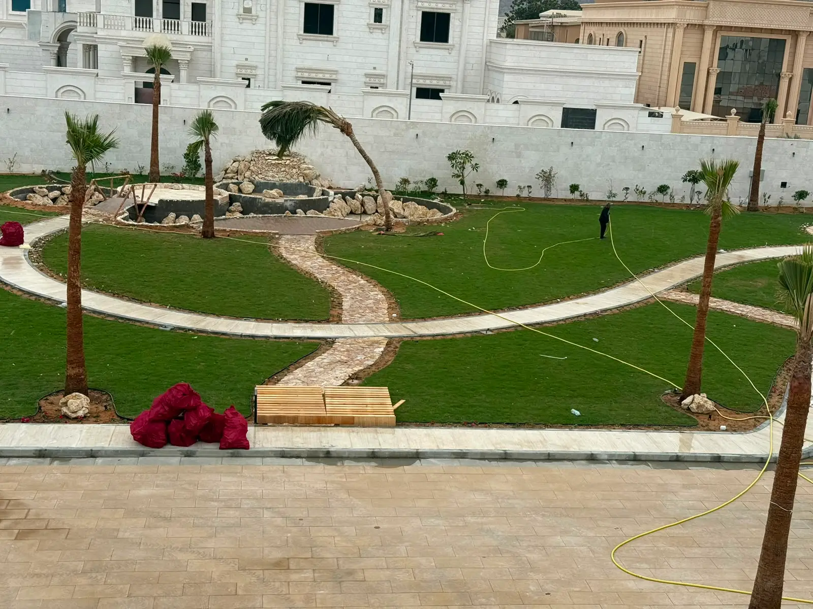 Landscaped estate courtyard with lawns and palms. NAM Landscaping serves villas and communities across Dubai